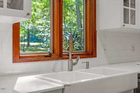 a kitchen with sink and cabinets