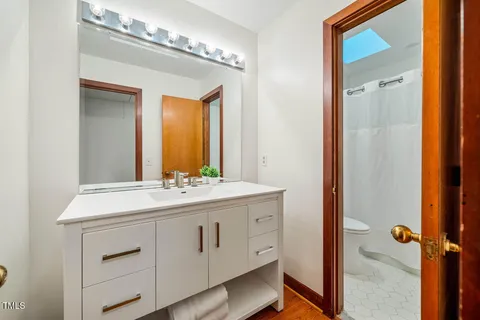 a bed sitting in a bedroom next to a lamp