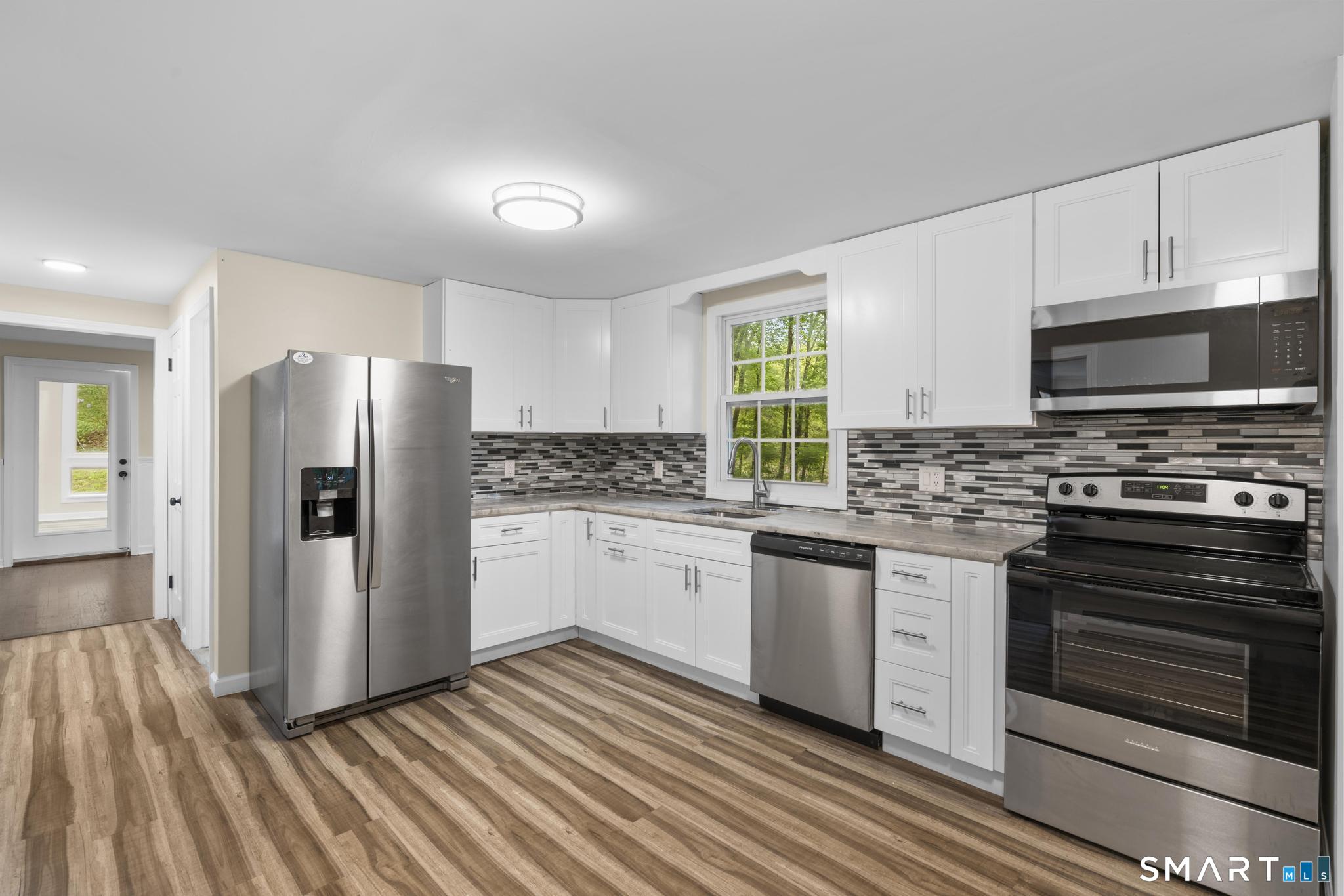 7 Sycamore Terrace Windham, CT 06280 - Photo 10 of 40 a kitchen with granite countertop a refrigerator stove and sink