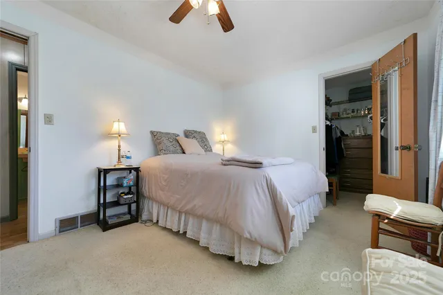 a bedroom with a bed and a chair in it