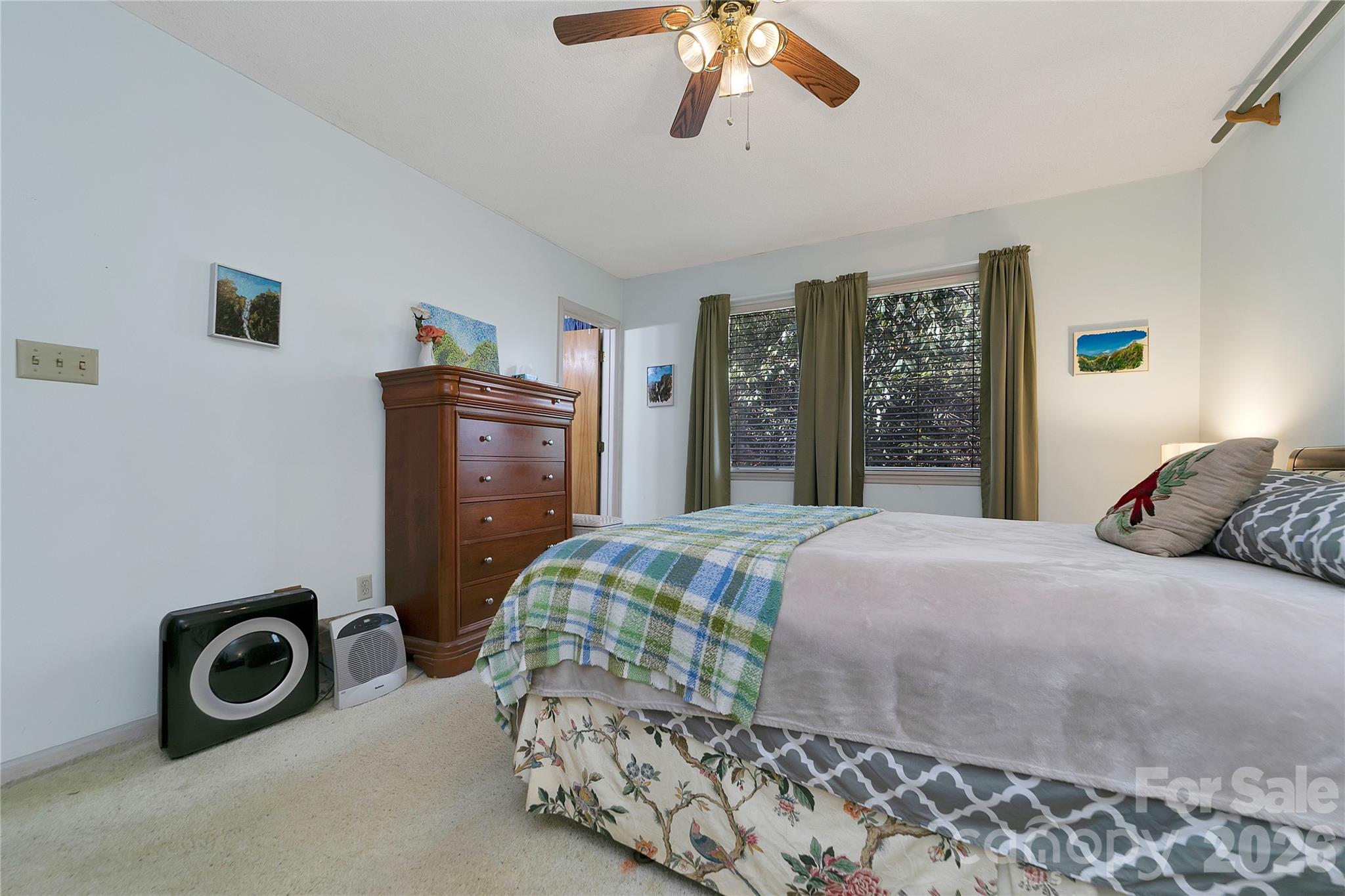 177 Walelu Court Brevard, NC 28712 - Photo 15 of 26 a bedroom with a bed and a chandelier