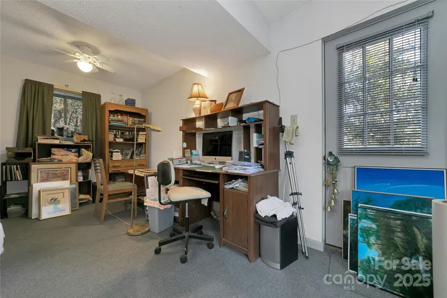 a view of a workspace with furniture and a fireplace