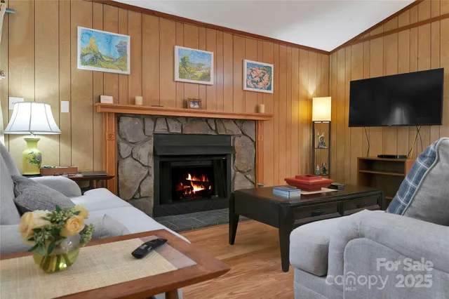a living room with furniture flat screen tv and a fireplace