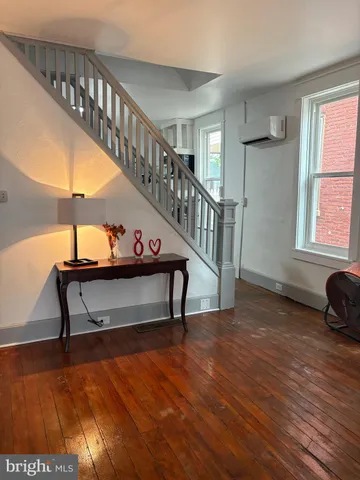 a view of staircase with a table and a potted plant
