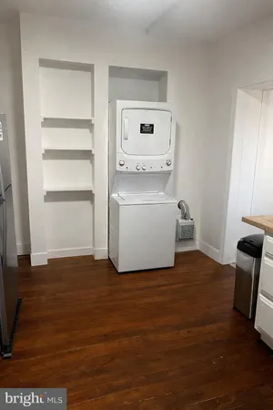 a view of kitchen with wooden floor and electronic appliances