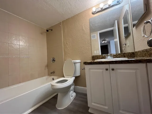 a bathroom with a sink a toilet and bathtub