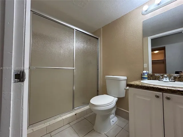 a bathroom with a toilet a sink and shower