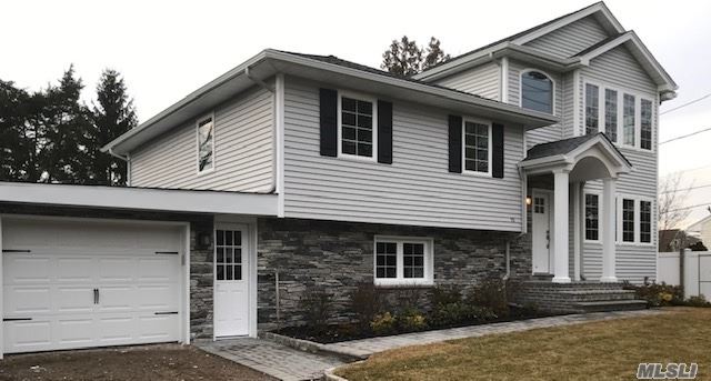 151 Cold Spring Road Syosset, NY 11791 - Photo 1 of 1 a front view of a house with garage