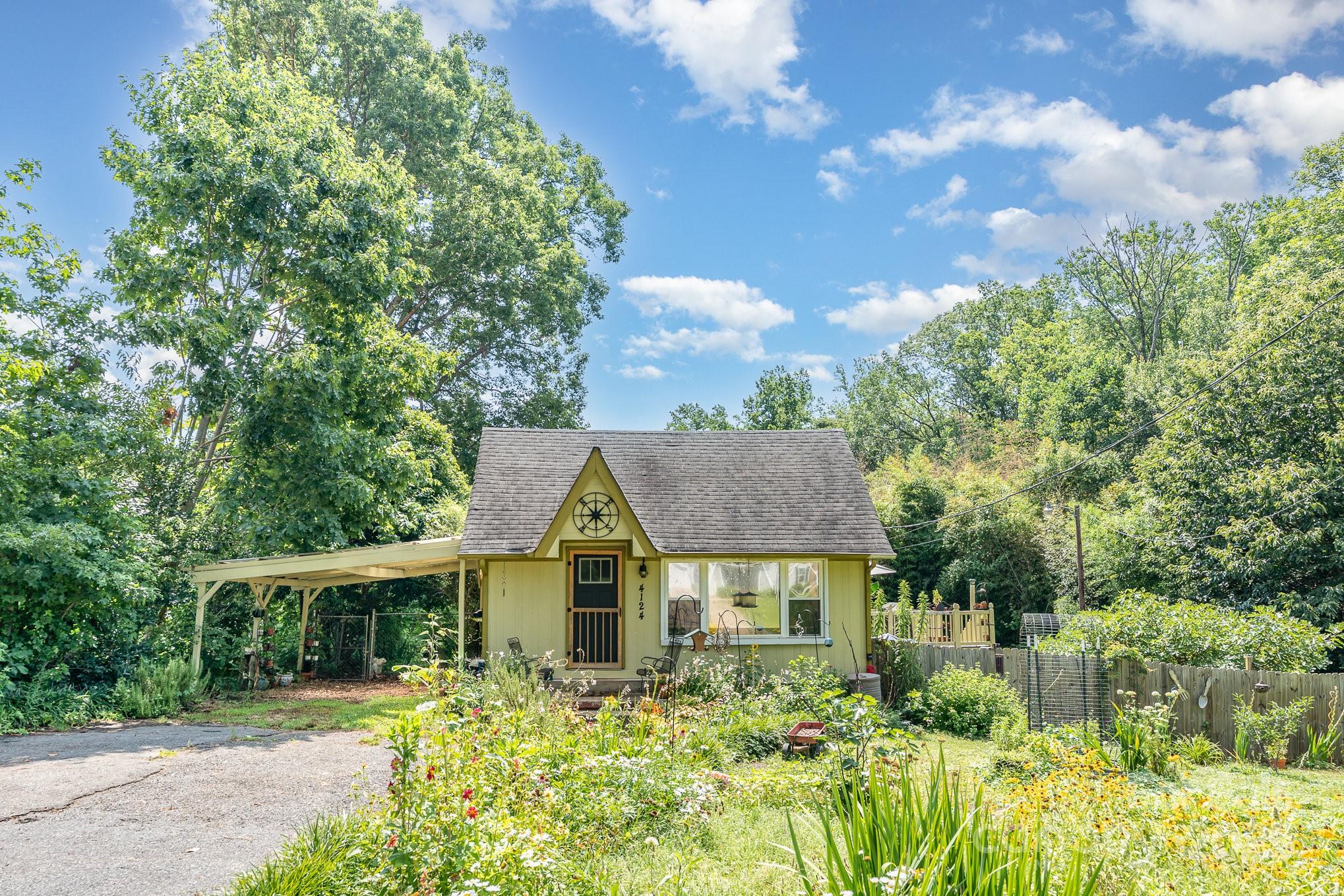 4124 Oakwood Road Charlotte, NC 28269 - Photo 1 of 20 a front view of a house with a yard