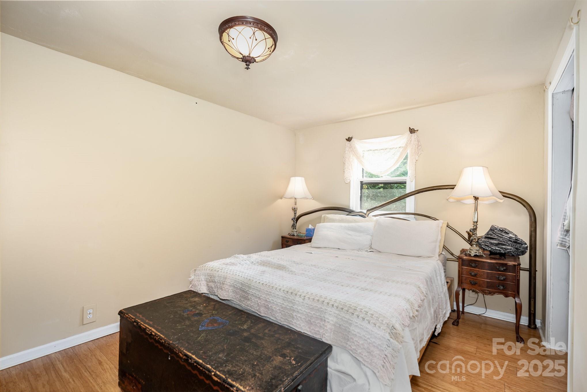 4124 Oakwood Road Charlotte, NC 28269 - Photo 12 of 20 a bedroom with a bed and a dresser