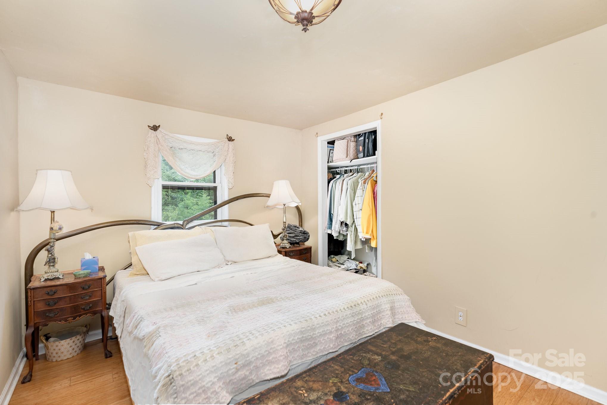 4124 Oakwood Road Charlotte, NC 28269 - Photo 13 of 20 a bedroom with a bed and a night stand