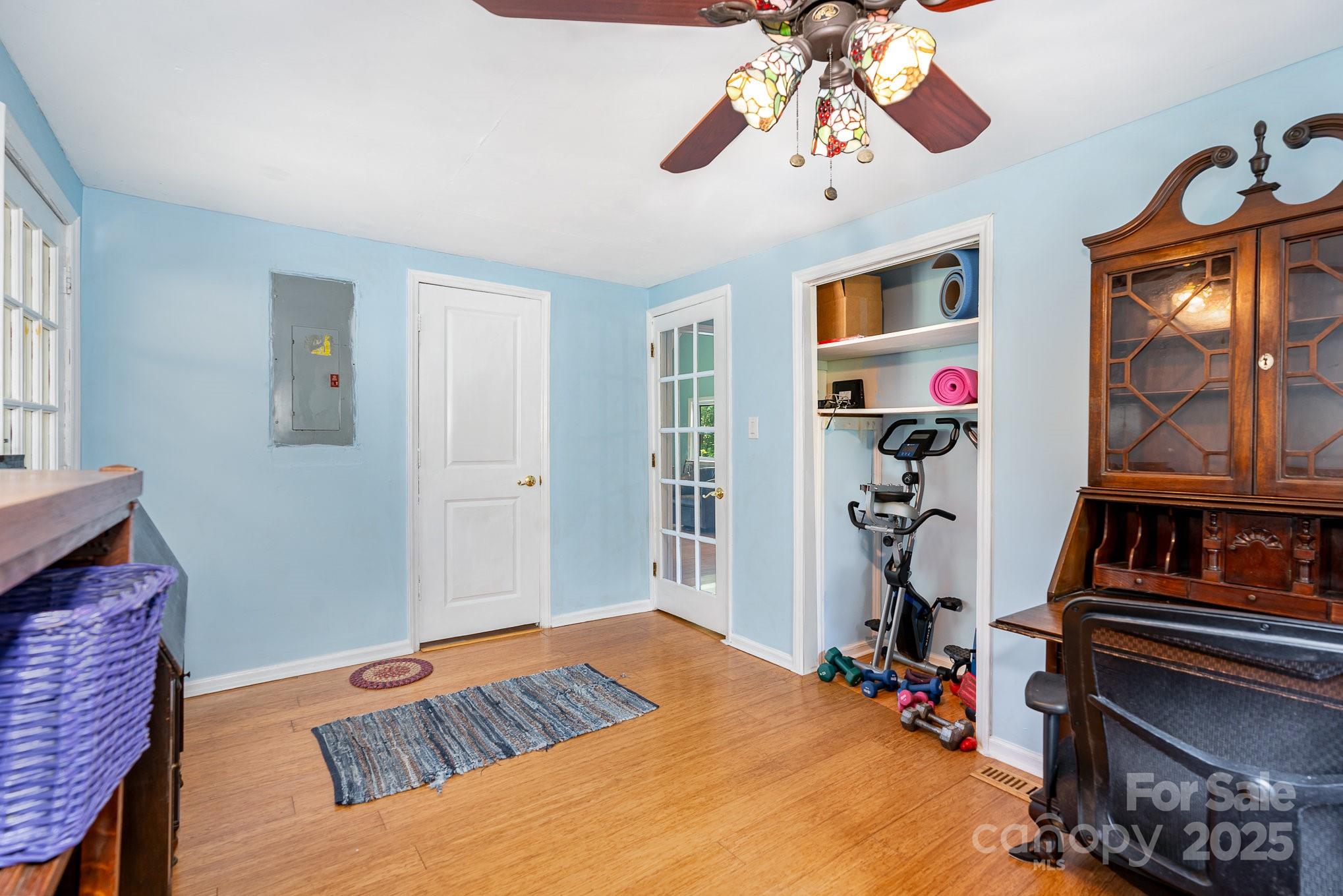 4124 Oakwood Road Charlotte, NC 28269 - Photo 16 of 20 a bedroom with a bed and a chandelier