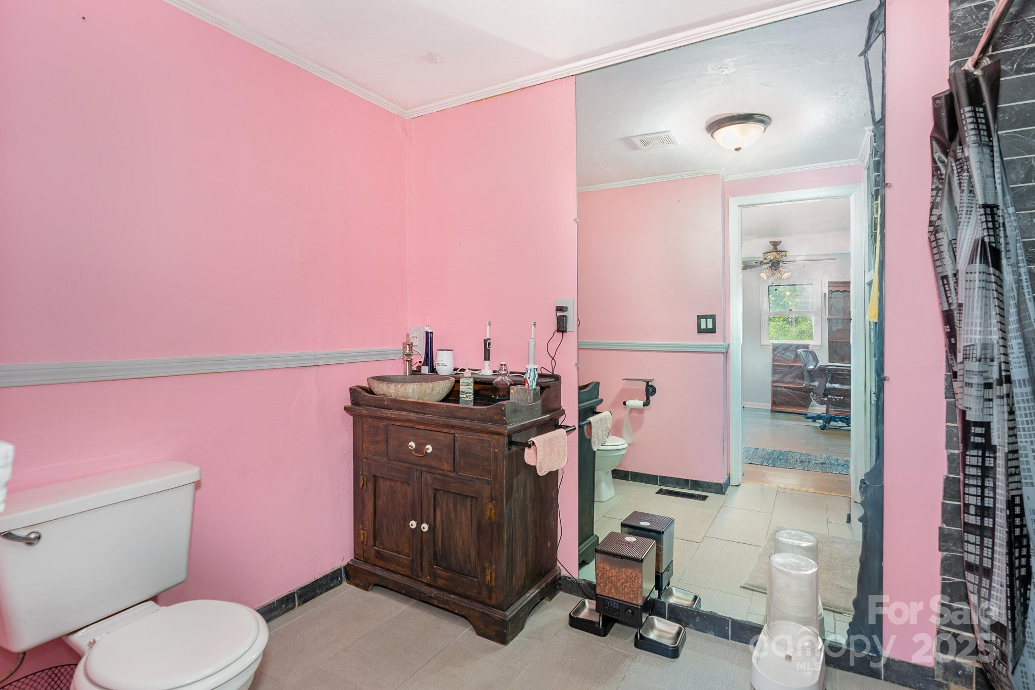 4124 Oakwood Road Charlotte, NC 28269 - Photo 17 of 20 a bathroom with a sink a toilet and mirror
