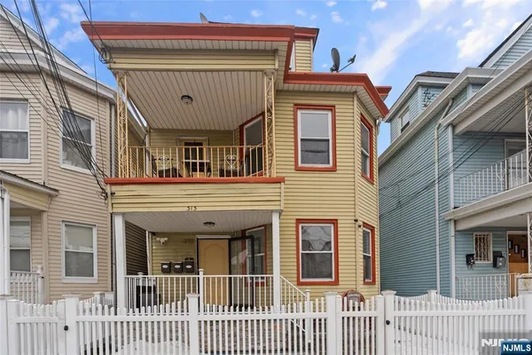 a view of a house with a small deck