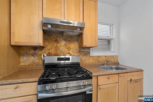 a stove top oven sitting inside of a kitchen