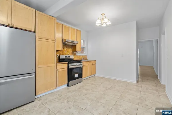 a kitchen with stainless steel appliances a refrigerator sink and cabinets