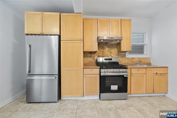 a kitchen with a stove and a refrigerator