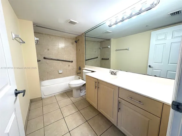 a bathroom with a double vanity sink toilet mirror and shower