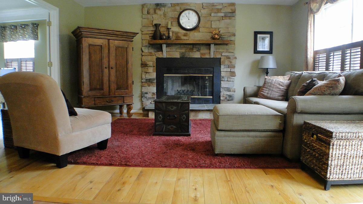 7671 Swallow Road Sykesville, MD 21784 - Photo 3 of 30 a living room with furniture and a fireplace