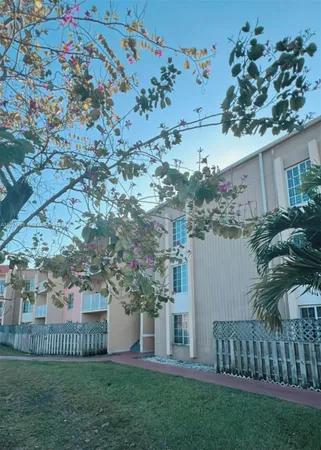 a view of a house with a tree in a yard