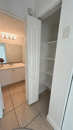 a view of kitchen with refrigerator and door