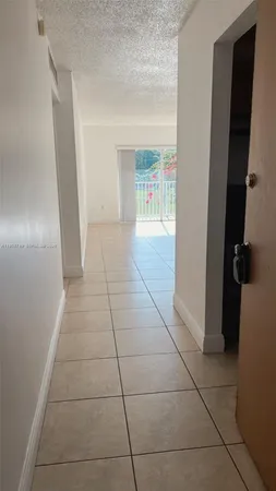 an empty room with windows and entrance