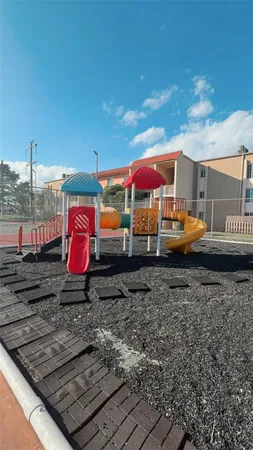a front view of a house with a yard and potted plants