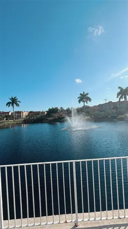 a view of a lake with houses in the back