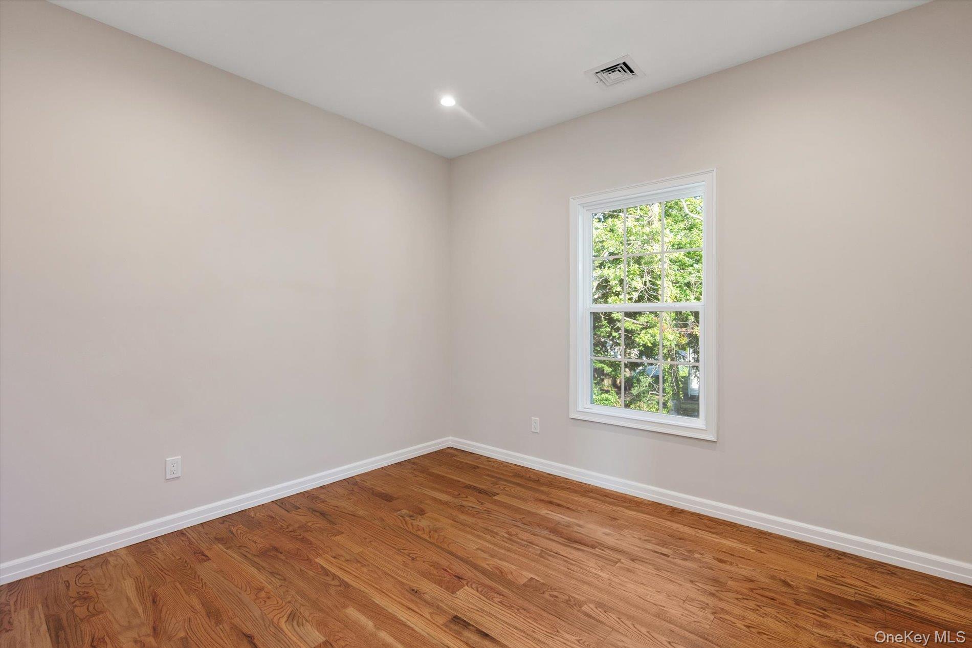 2 Gail-grace Court Copiague, NY 11726 - Photo 17 of 27 Empty room featuring wood finished floors and recessed lighting