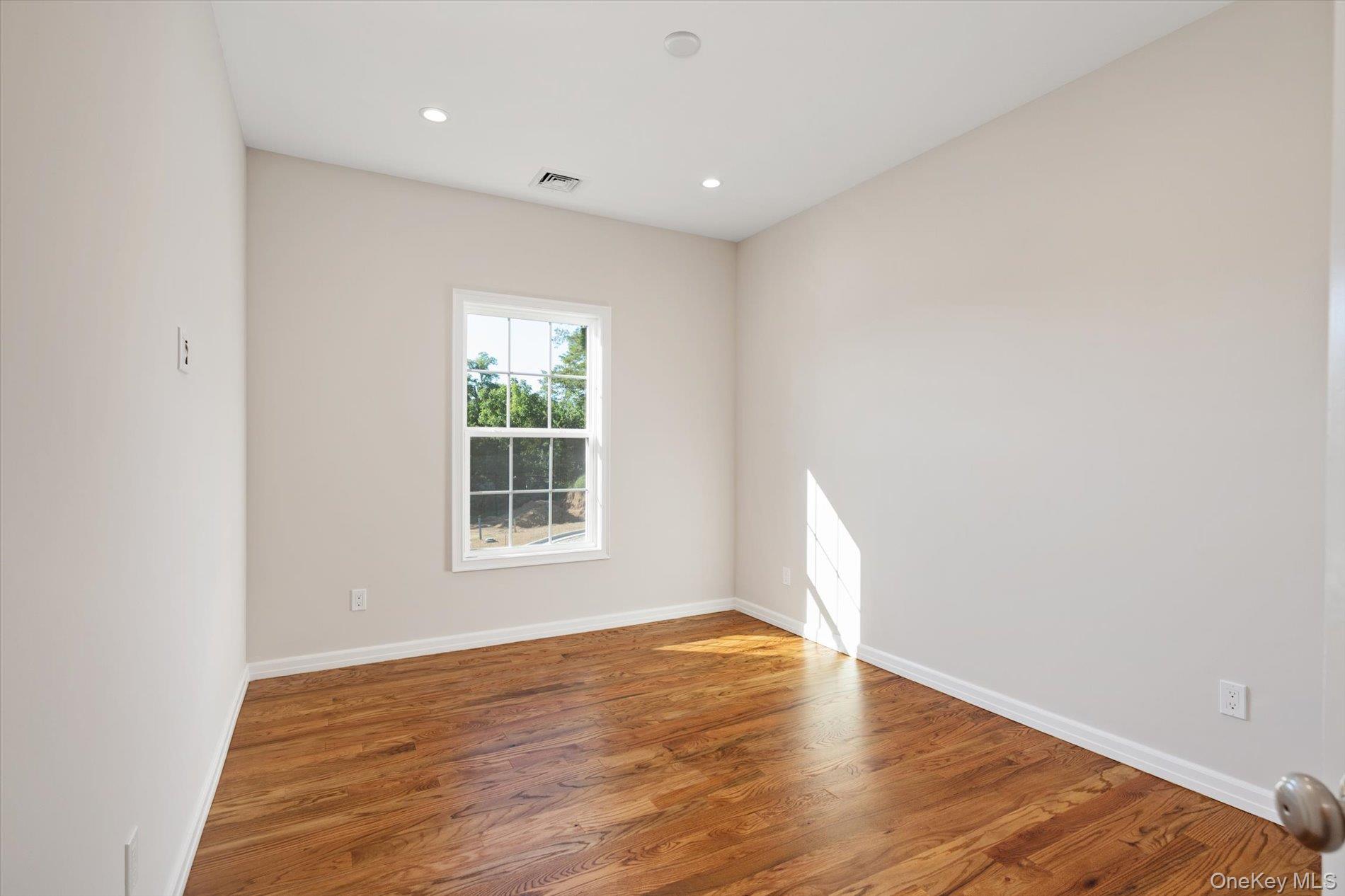 2 Gail-grace Court Copiague, NY 11726 - Photo 19 of 27 Spare room with wood finished floors and recessed lighting