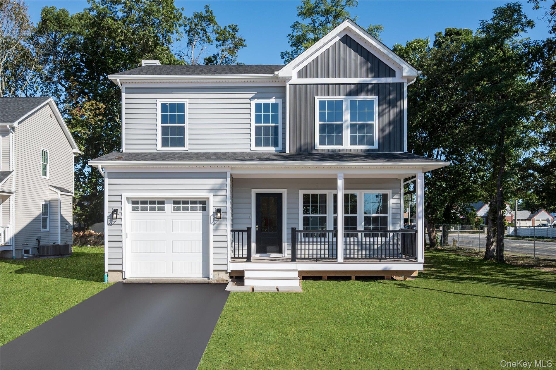 2 Gail-grace Court Copiague, NY 11726 - Photo 2 of 27 View of front of home featuring a front lawn, covered porch, board and batten siding, and a garage