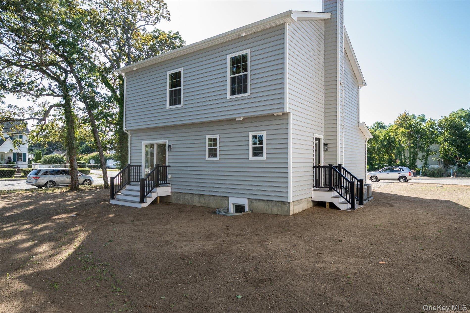 2 Gail-grace Court Copiague, NY 11726 - Photo 22 of 27 Back of property with a chimney