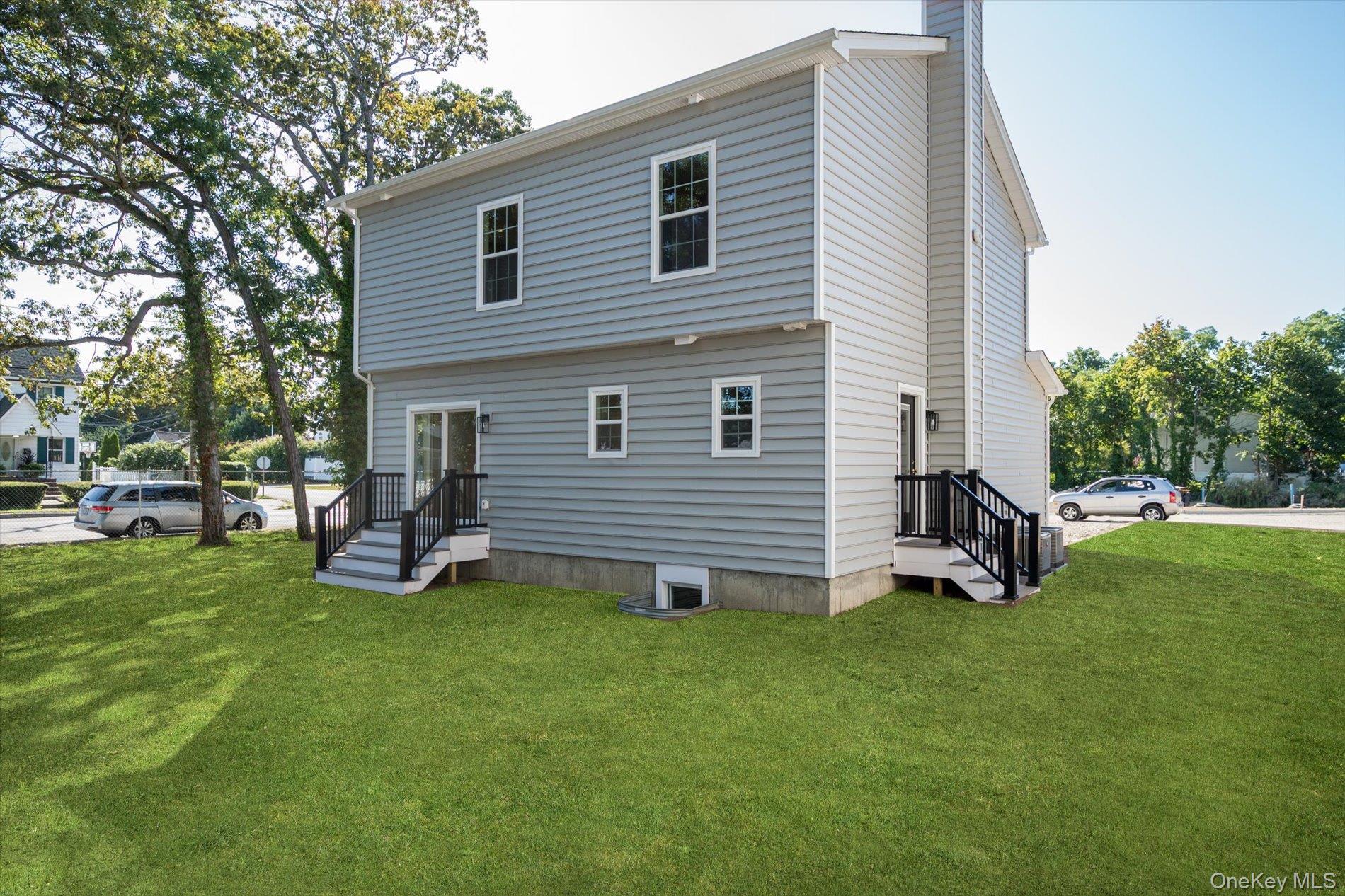 2 Gail-grace Court Copiague, NY 11726 - Photo 23 of 27 Rear view of property featuring a lawn and a chimney