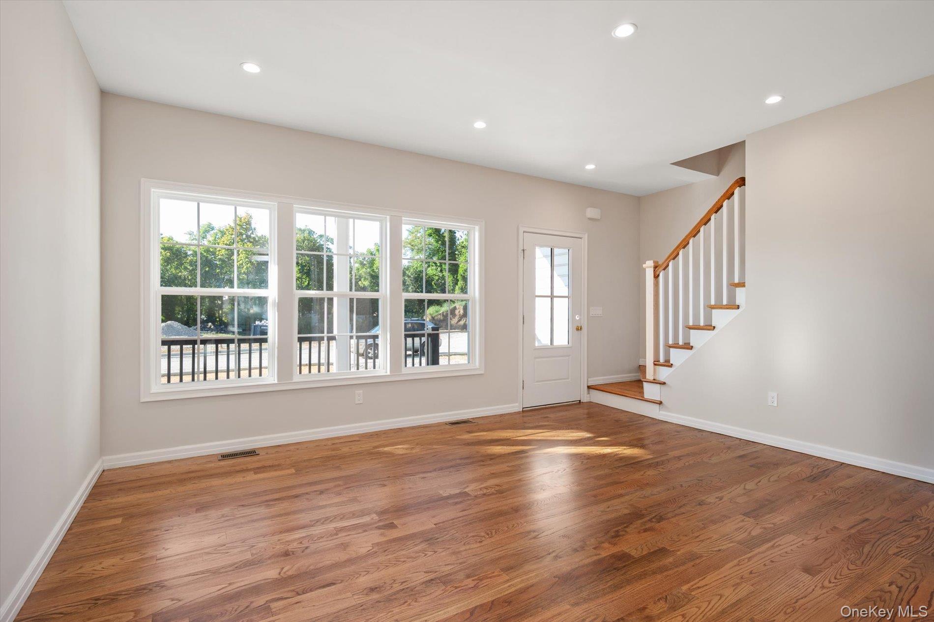 2 Gail-grace Court Copiague, NY 11726 - Photo 7 of 27 Entrance foyer with healthy amount of natural light, stairs, recessed lighting, and light wood-style flooring