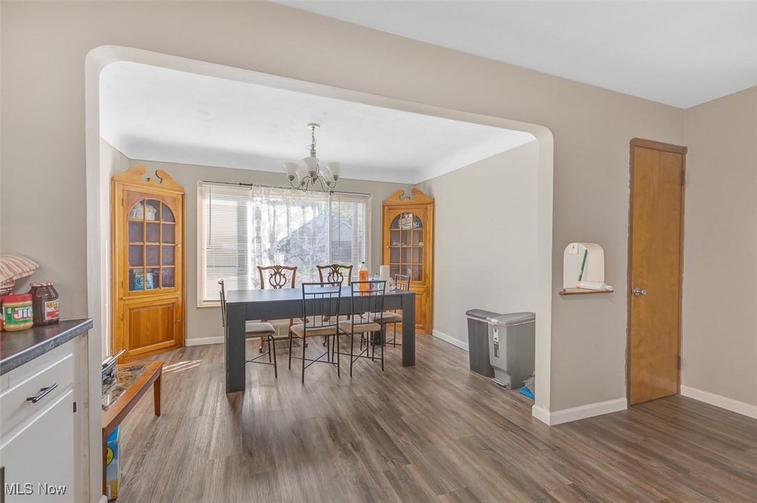 6136 Ridge Road Cleveland, OH 44129 - Photo 11 of 40 Dining space featuring dark wood-style flooring and a chandelier