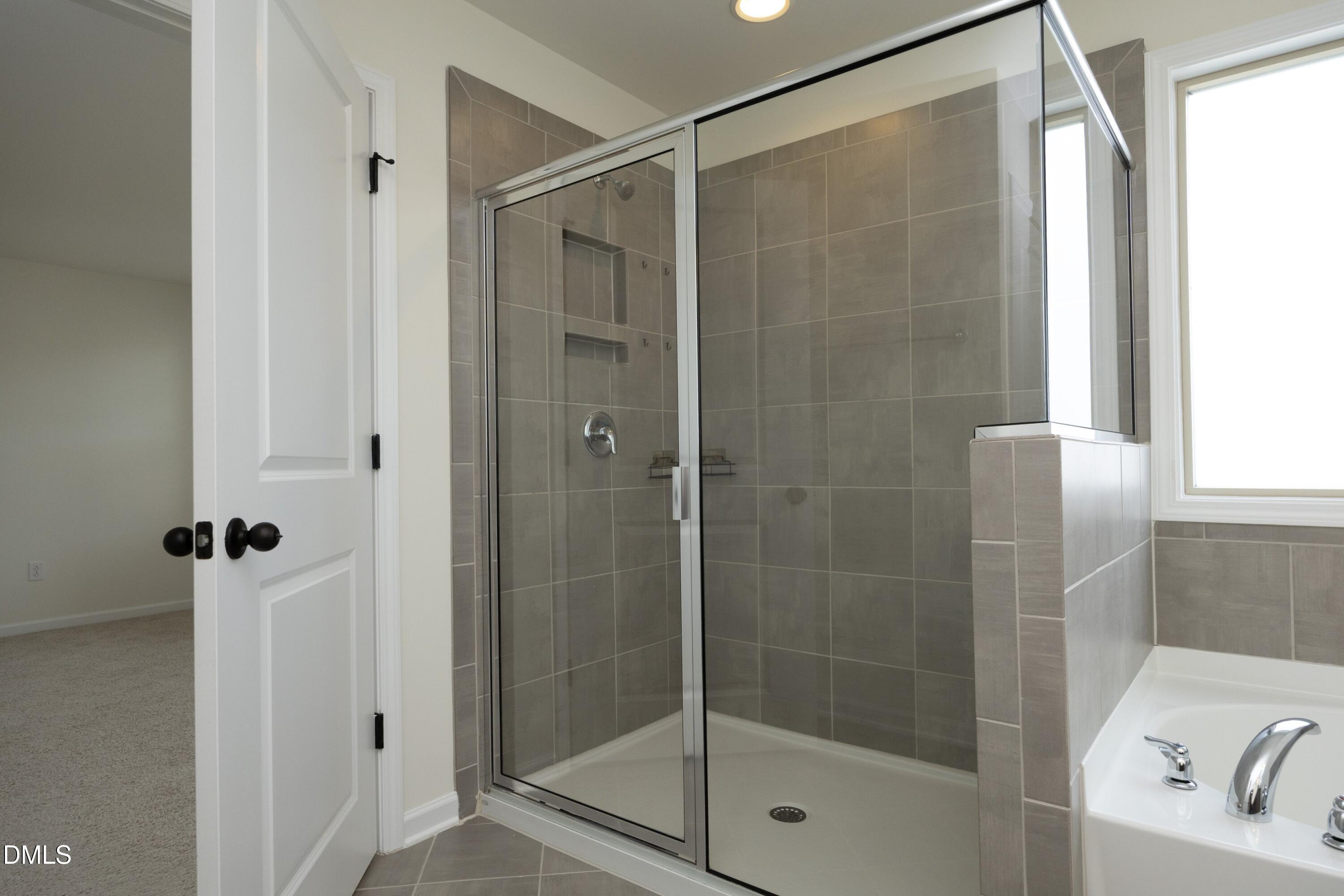 824 Country Downs Road Wake Forest, NC 27587 - Photo 24 of 41 a bathroom with a shower and a sink