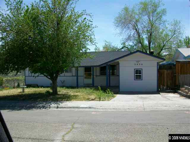 3430 Rauscher Drive Reno, NV 89503 - Photo 1 of 9 a front view of a house with a yard and a garage