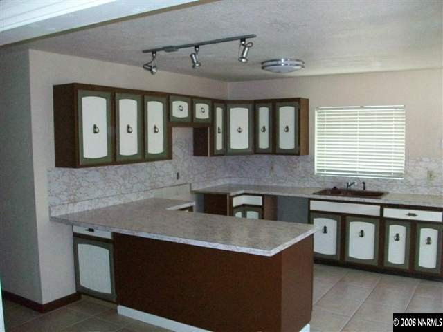 3430 Rauscher Drive Reno, NV 89503 - Photo 2 of 9 a kitchen with stainless steel appliances granite countertop a sink stove and cabinets