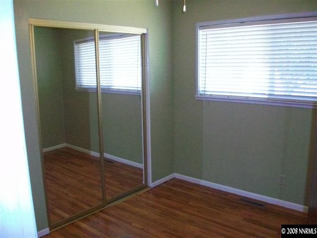 3430 Rauscher Drive Reno, NV 89503 - Photo 5 of 9 a view of an empty room with wooden floor and a window