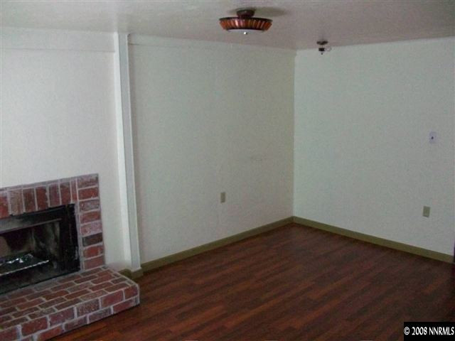 3430 Rauscher Drive Reno, NV 89503 - Photo 7 of 9 a view of a room with wooden floor a fireplace and a window