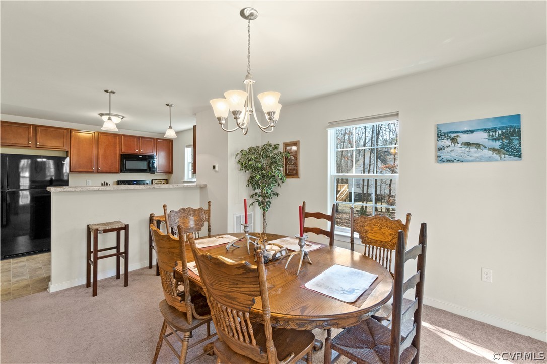 4685 New Line Road Gum Spring, VA 23065 - Photo 8 of 14 a view of a dining room with furniture a chandelier and wooden floor