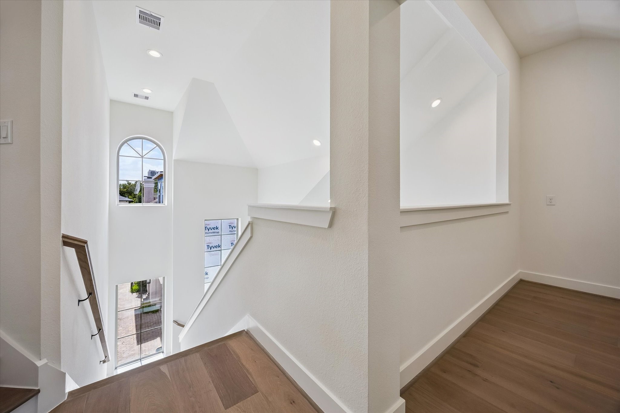 5329 Dora Street Houston, TX 77005 - Photo 19 of 43 Soaring ceilings and expansive windows flood every level of the home with natural light, creating a bright, airy atmosphere as you ascend through each thoughtfully designed space.