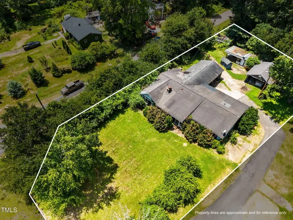 an aerial view of a house with a garden and plants