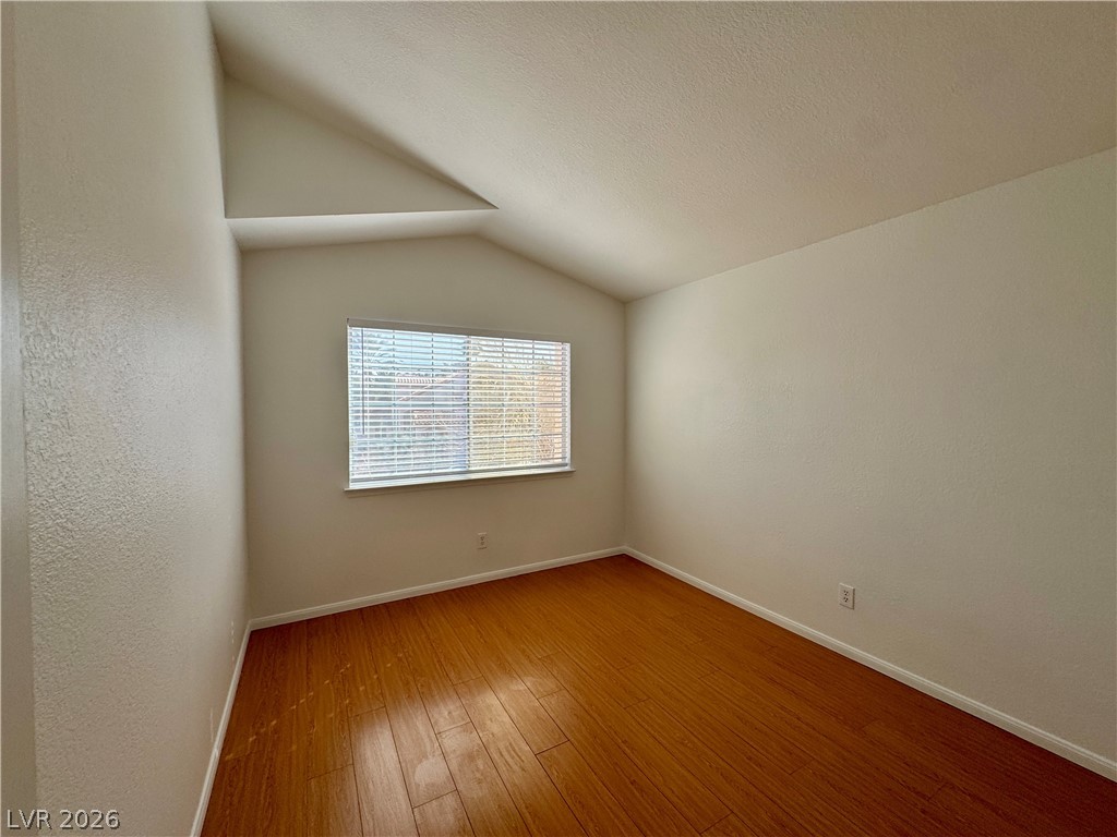 73 Sea Holly Way Henderson, NV 89074 - Photo 54 of 59 Empty room with hardwood / wood-style flooring and a textured wall