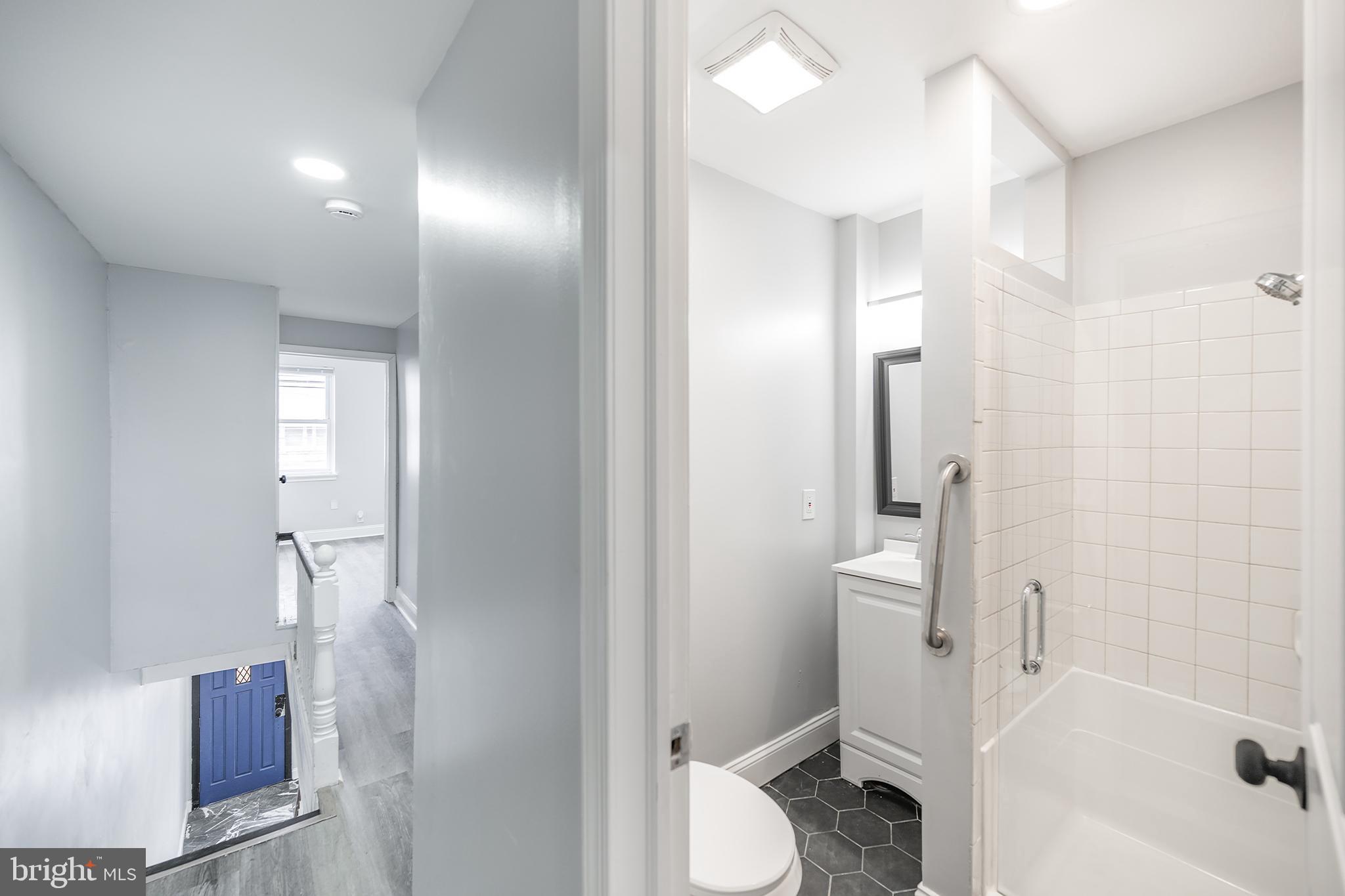 3097 Memphis Street Philadelphia, PA 19134 - Photo 17 of 26 a bathroom with a sink a toilet and shower