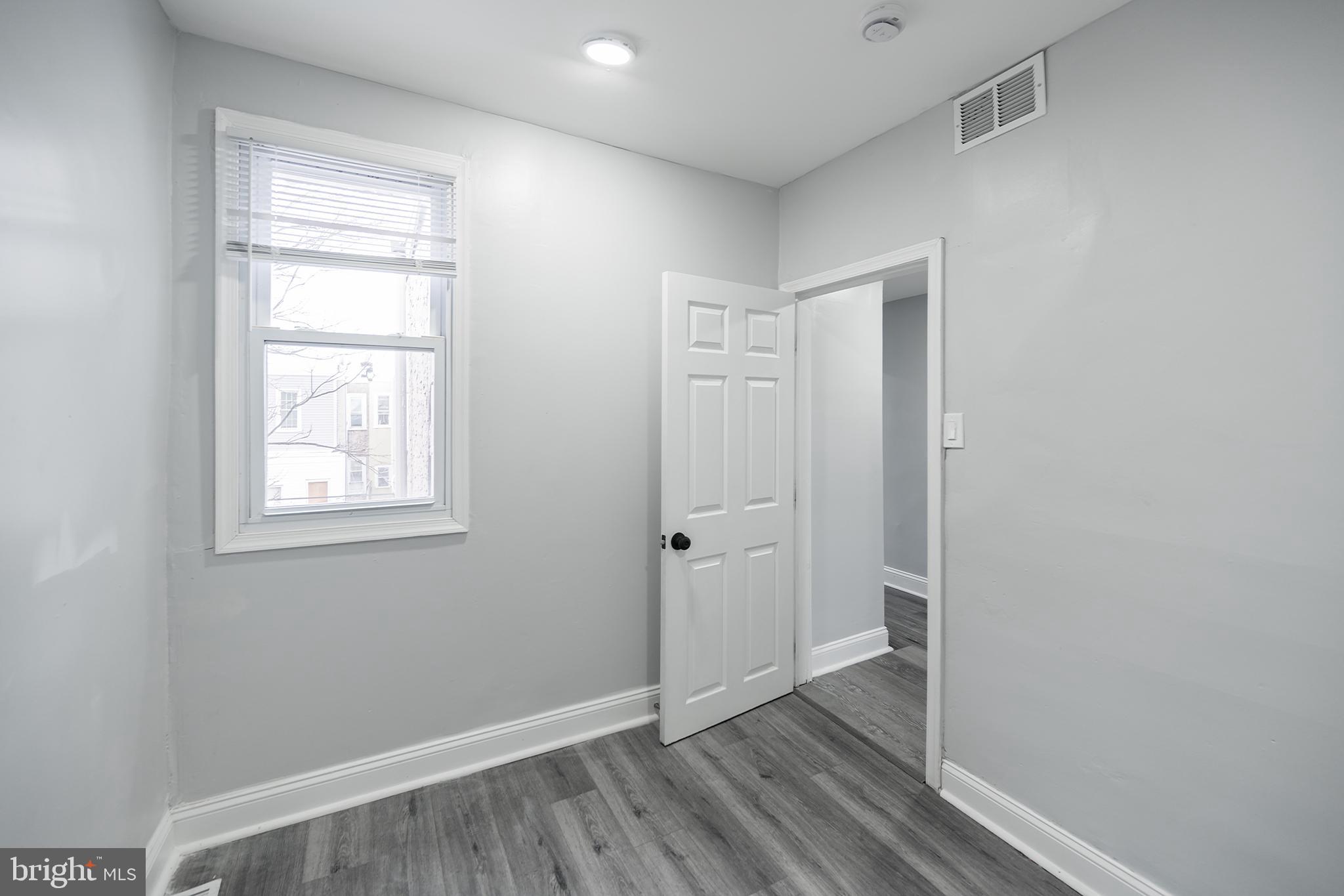 3097 Memphis Street Philadelphia, PA 19134 - Photo 20 of 26 a view of an empty room with wooden floor and a window