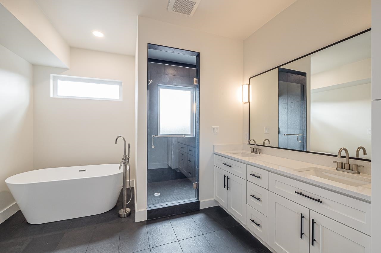 2394 Ridge Cir Drive, Unit B Grand Junction, CO 81507 - Photo 22 of 42 a bathroom with a white tub shower sink and mirror