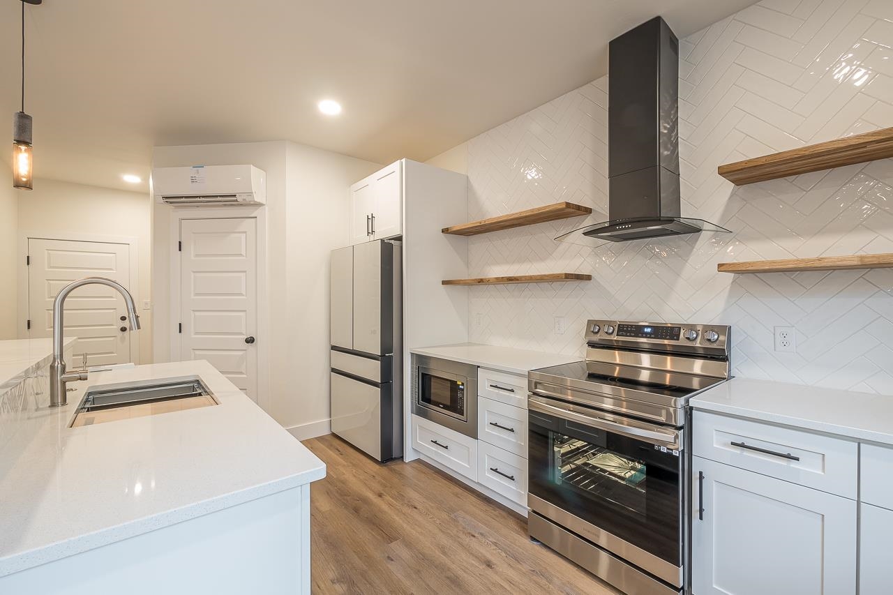 2394 Ridge Cir Drive, Unit B Grand Junction, CO 81507 - Photo 6 of 42 a kitchen with a sink stainless steel appliances and cabinets