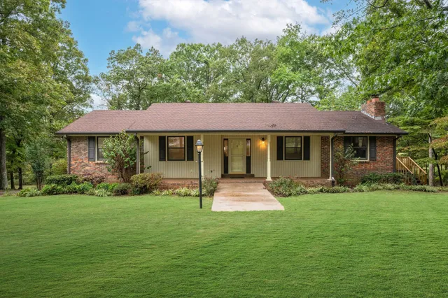 a front view of a house with a yard porch and furniture