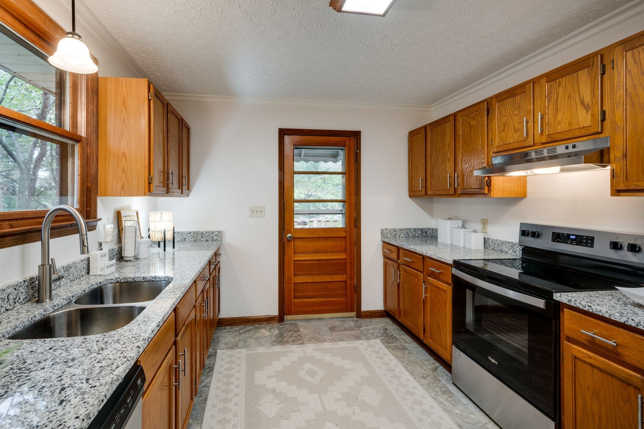 1085 Claylick Road White Bluff, TN 37187 - Photo 12 of 48 a kitchen with granite countertop a sink dishwasher stove and cabinets